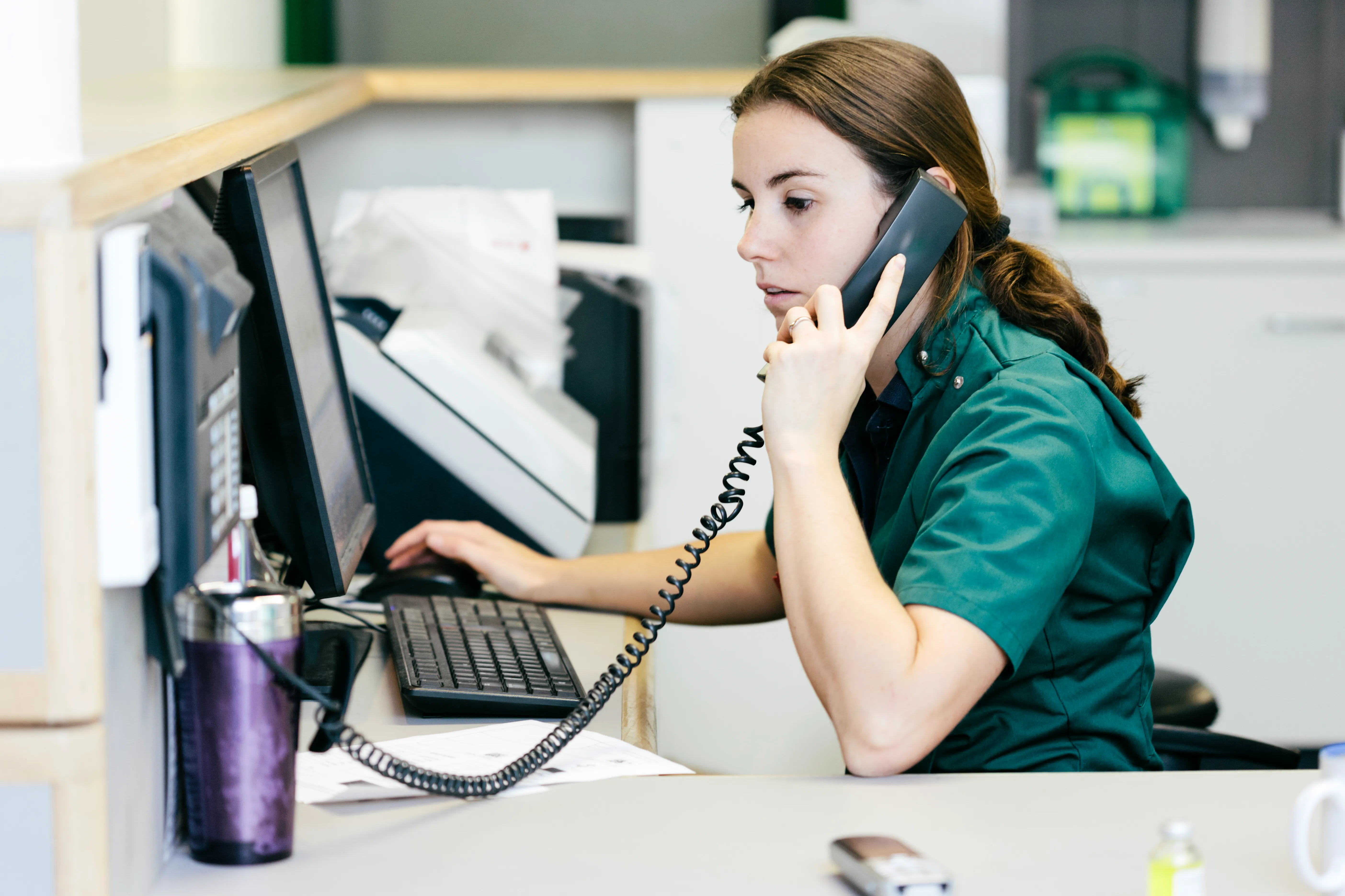 Person working in a hospital answering the phone