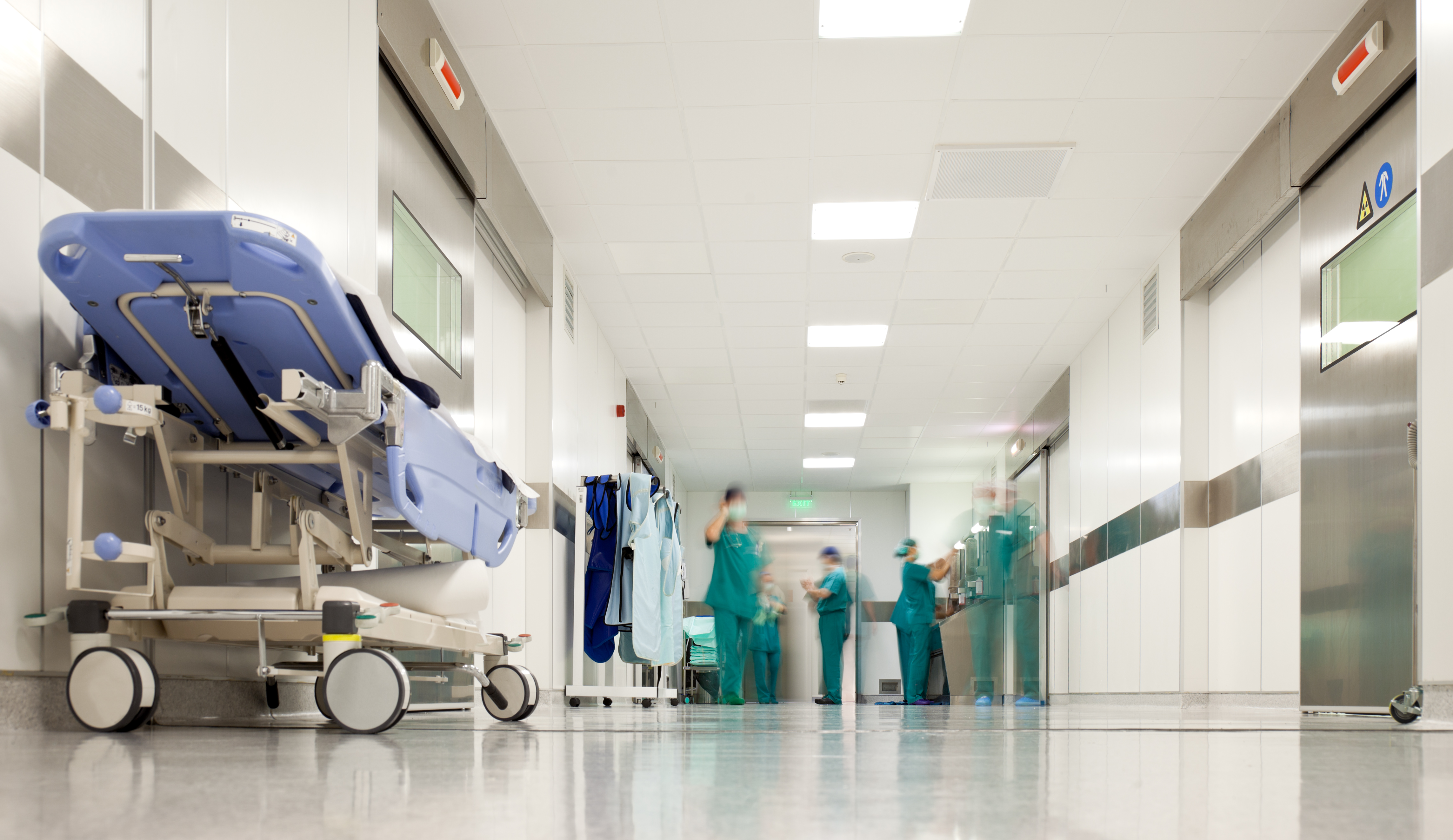 Hospital corridor with beds and hospital staff
