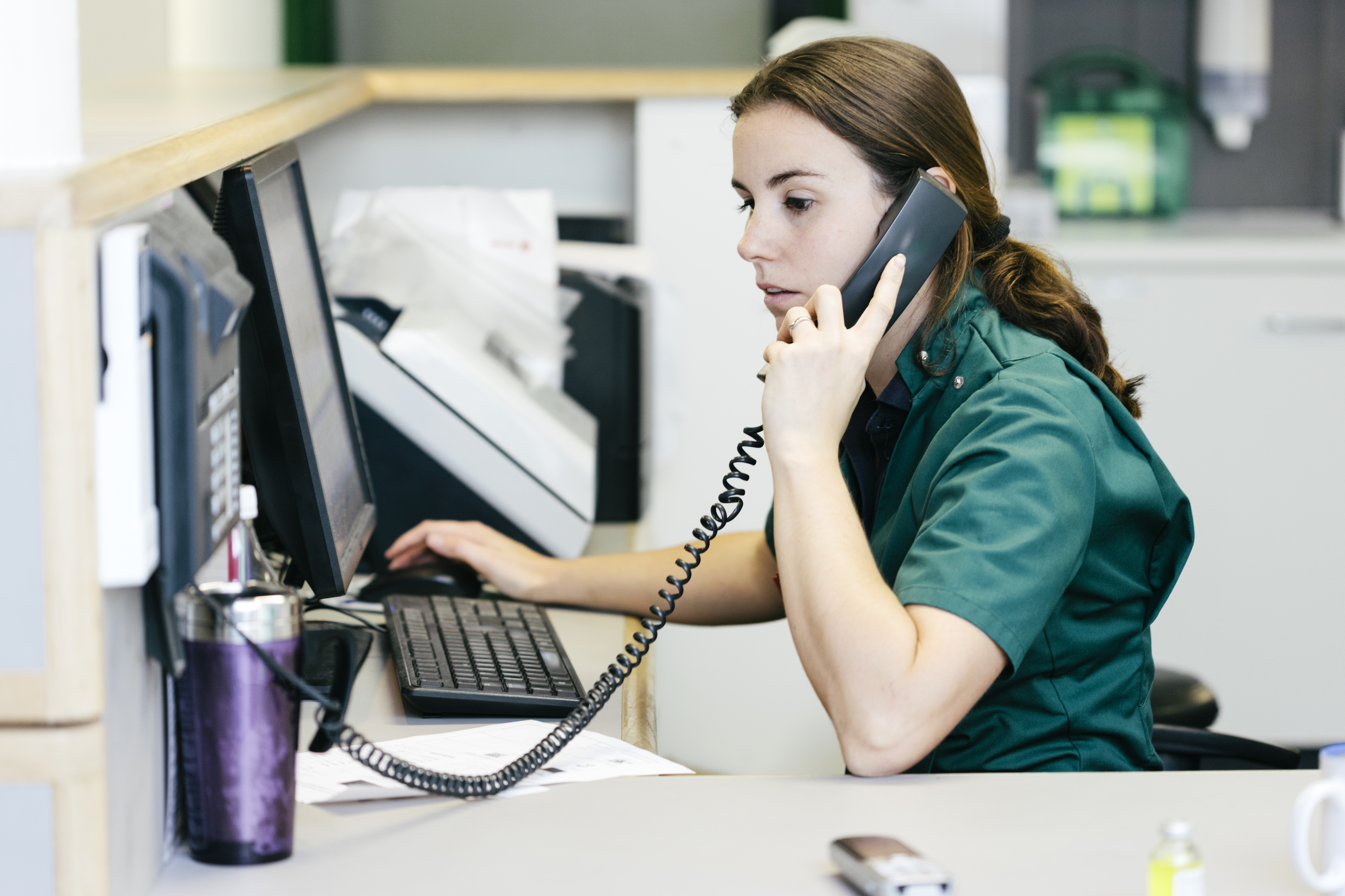 Person working in a hospital answering the phone